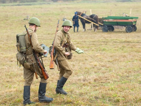 RUSSIA, BORODINO - OCTOBER 12: Unidentified  soldiers of communikation squad on reenactment of the battle in WWII near the Borodino village in 1941, in Moscow region, Borodino, on 12 October, 2014, Russiaのeditorial素材