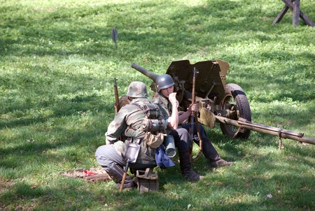 ELECTROUGLI CITY - MAY 9: Cannon squad in action during reenactment of the last battle in WWII on...