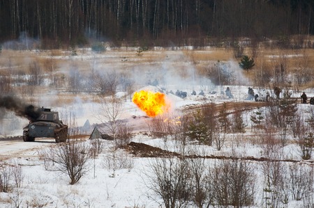 RUSSIA, LIZLOVO - DECEMBER 14: Fired road and burning tank on reenactment of the counterattack under the Moscow in 1941 in World War II, in Moscow region, Lizlovo village, Russia, 2014のeditorial素材