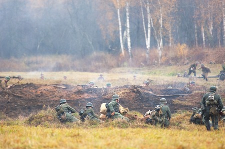 RUSSIA, BORODINO - OCTOBER 12: Unidentified armed german soldiers sit down on the field and defence on reenactment of the battle in WWII near the Borodino village in 1941, in Moscow region, Borodino, on 12 October, 2014, Russiaのeditorial素材