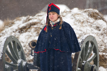 RUSSIA, APRELEVKA - FEBRUARY 7: Unidentified woman in retro uniform stand near the cannon on...