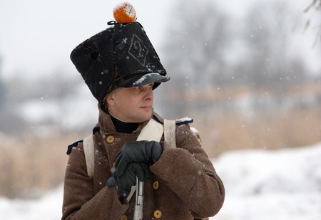 RUSSIA, APRELEVKA - FEBRUARY 7: Unidentified napoleonic war russian soldier with rifle in retro costume on reenactment of the Napoleonic maneuvers near the Aprelevka city, in 1812. Moscow region, Aprelevka, 7 February, 2015, Russiaのeditorial素材
