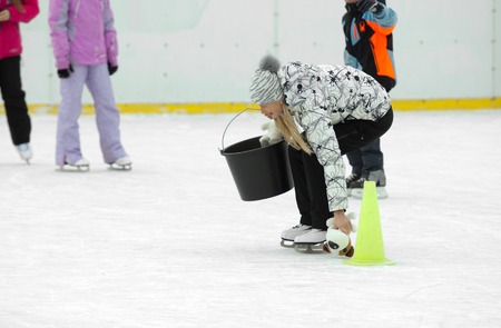 MOSCOW - JANUARY 25: Unidentified woman collect the toys into the bucket on family sport event on January 25, 2015 in Moscow, Russiaのeditorial素材