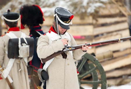 RUSSIA, APRELEVKA - FEBRUARY 7: Unidentified soldier reload the musket on reenactment of the Napoleonic maneuvers near the Aprelevka city, in 1812. Moscow region, Aprelevka, 7 February, 2015, Russiaのeditorial素材