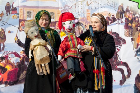 PODOLSK, OSTAFIEVO, RUSSIA - FEBRUARY 21: Unidentified women with folk dolls on a scene on Russian religious and folk holiday Maslenitsa in estate Ostafievo on February 21, 2015, near Podolsk, Russiaのeditorial素材