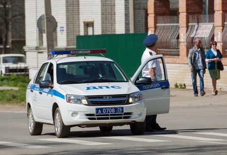 RUSSIA ROSTOV CITY MAY 9: Unidentified police man and car on Victory day parade dedicated to 70 anniversary of WWII end on May September 2015 in Yaroslavl region Rostov the Great city Russiaのeditorial素材