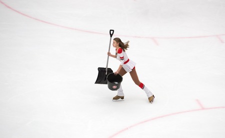 PODOLSK, RUSSIA - NOVEMBER 13, 2016: Unidentified cheerleader girl with shovel and bucket on hockey game Vityaz vs Severstal on Russia KHL championship on November 13, 2016, in Podolsk, Russia. Vityaz won 4:0のeditorial素材