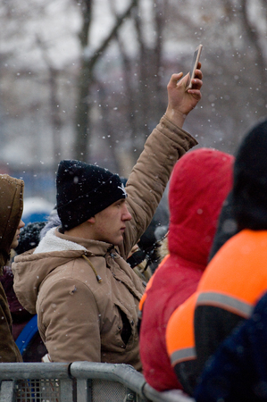 MOSCOW, RUSSIA - NOVEMBER 10, 2016: Unidentified man filming music show near the scene on city event of open Winter game season on November 11, 2016, in Moscow, Russiaのeditorial素材