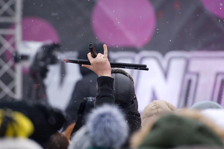 MOSCOW, RUSSIA - NOVEMBER 10, 2016: Unidentified spectator hold drum stick in hand during city event of open Winter game season on November 11, 2016, in Moscow, Russiaのeditorial素材