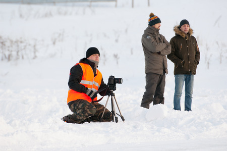 BREKHOVO, MOSCOW REGION, RUSSIA - JANUARY 21, 2017: Unidentified photographer filming during Winter open cup of DOSAAF MX Speedway on January 21, 2017のeditorial素材