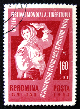 MOSCOW, RUSSIA - APRIL 2, 2017: A post stamp printed in Romania shows dancing woman in national dress, circa 1959のeditorial素材