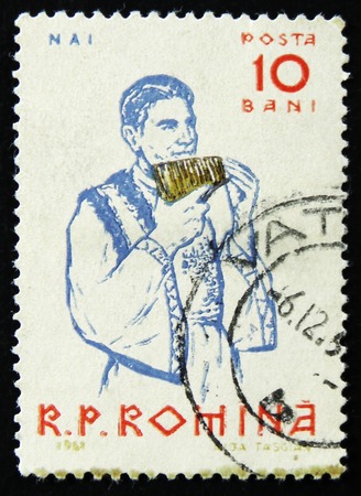 MOSCOW, RUSSIA - APRIL 2, 2017: A post stamp printed in Romania shows Peasants playing musical instruments, Panpipe, circa 1961のeditorial素材