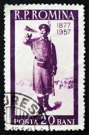 MOSCOW, RUSSIA - APRIL 2, 2017: A post stamp printed in Romania shows bugler, soldier with horn, 80th anniversary of Russian-Turkish war, circa 1957のeditorial素材