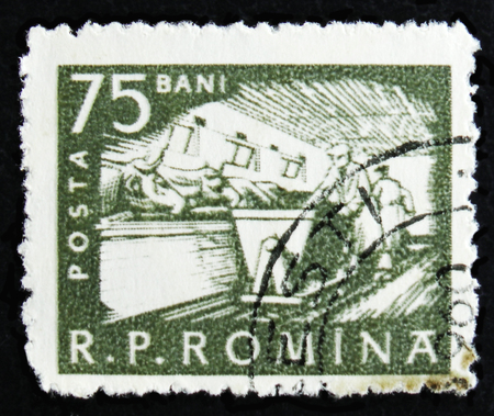 MOSCOW, RUSSIA - APRIL 2, 2017: A post stamp printed in Romania shows Cattle feeding, Farm workers, circa 1960のeditorial素材