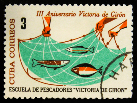 MOSCOW, RUSSIA - JULY 15, 2017: Rare stamp printed in Cuba shows Mash with fish, 
The 3rd Anniversary of The Giron Victory, circa 1964のeditorial素材
