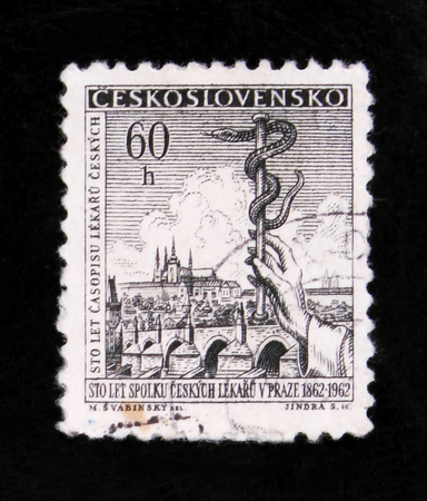 MOSCOW, RUSSIA - JUNE 20, 2017: A stamp printed in Czechoslovakia shows hand with caduceus of Charles Bridge and Prague, 100 years of Czech medicine, circa 1962のeditorial素材