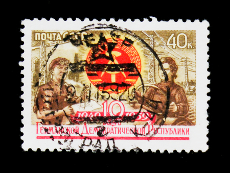 MOSCOW, RUSSIA - JUNE 26, 2017: Rsre stamp printed in USSR (Russia) shows man an woman workers, 10th...