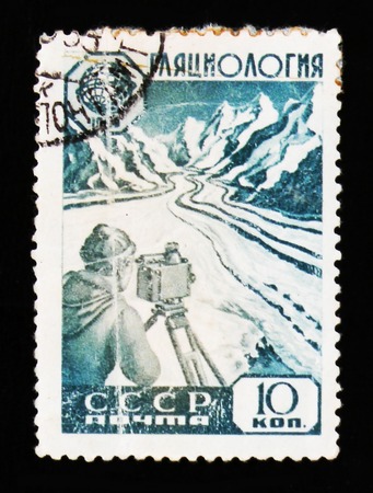 MOSCOW, RUSSIA - JUNE 26, 2017: A stamp printed in USSR (Russia) shows glaciology researcher with device at glacier in mountain, circa 1959のeditorial素材