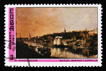 MOSCOW, RUSSIA - JUNE 26, 2017: A stamp printed in Cuba shows painting Guadalquivir River, by Manuel Barron, the series "National museum paintings", circa 1976のeditorial素材