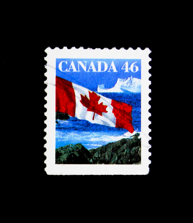 MOSCOW, RUSSIA - NOVEMBER 24, 2017: A stamp printed in Canada shows Canadian Flag and Iceberg, Definitives 1989-2005 serie, circa 1998のeditorial素材