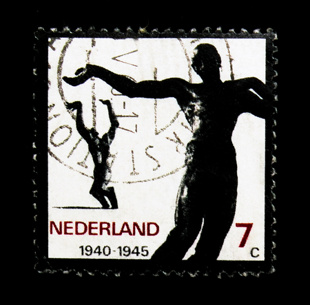 MOSCOW, RUSSIA - NOVEMBER 24, 2017: A stamp printed in Netherlands shows Sculptures "Fallen" and "Ravaged City", Resistance serie, circa 1965のeditorial素材