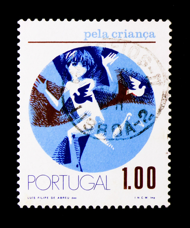MOSCOW, RUSSIA - NOVEMBER 24, 2017: A stamp printed in Portugal shows Child running to left, For the Child serie, circa 1973のeditorial素材