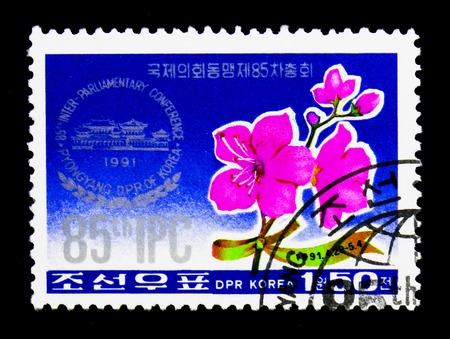 MOSCOW, RUSSIA - NOVEMBER 24, 2017: A stamp printed in Democratic People's republic of Korea shows Conference emblem and azalea, 85th Interparliamentary Union Conference, Pyongyang serie, circa 1991のeditorial素材