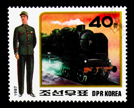 MOSCOW, RUSSIA - NOVEMBER 24, 2017: A stamp printed in Democratic People's republic of Korea shows Train conductor, steam locomotive, Uniforms of railway staff serie, circa 1987のeditorial素材