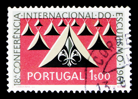 MOSCOW, RUSSIA - MAY 16, 2018: A stamp printed in Portugal shows Tents and Scout emblems, serie, circa 1962のeditorial素材