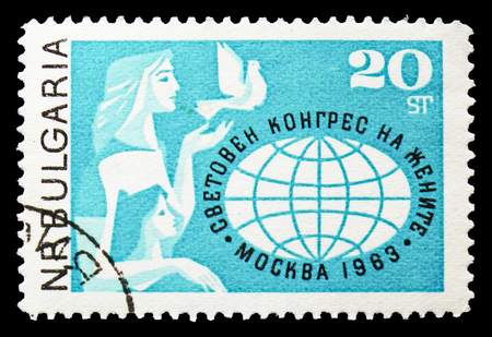 MOSCOW, RUSSIA - SEPTEMBER 15, 2018: A stamp printed in Bulgaria shows Woman with Child and Dove of Peace, World Globe, World Women's Congress, Moscow serie, circa 1963のeditorial素材