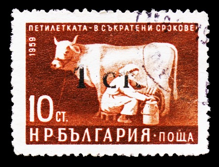 MOSCOW, RUSSIA - SEPTEMBER 15, 2018: A stamp printed in Bulgaria shows Woman milking Cow, Five-Year Plan in Shorter Time Limits serie, circa 1962のeditorial素材
