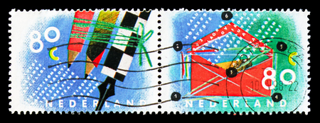 MOSCOW, RUSSIA - AUGUST 18, 2018: Two stamps printed in Netherlands shows Writing mail, Ten for your letters serie, circa 1993のeditorial素材