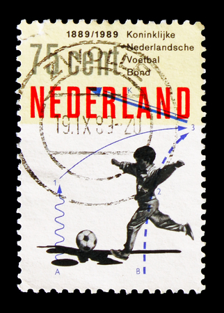 MOSCOW, RUSSIA - AUGUST 18, 2018: A stamp printed in Netherlands shows Boy with football, 100 years...