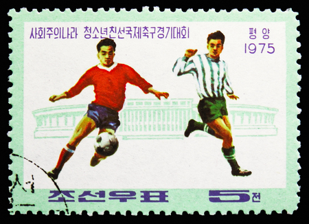 MOSCOW, RUSSIA - OCTOBER 21, 2018: A stamp printed in Korea shows Players and Stadium, Socialist Countries' Junior Friendship Football Tournament serie, circa 1975のeditorial素材