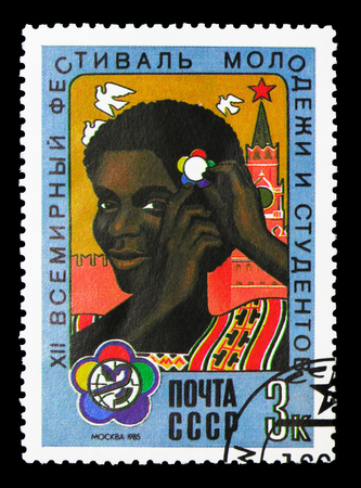 MOSCOW, RUSSIA - MARCH 31, 2018: A stamp printed in USSR (Russia) shows Girl with festival badge, 12th World Youth and Students' Festival serie, circa 1985のeditorial素材