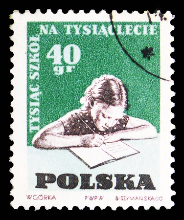 MOSCOW, RUSSIA - SEPTEMBER 15, 2018: A stamp printed in Poland shows Child doing homework, 1000 schools on 1000th Anniversary of Poland serie, circa 1959のeditorial素材