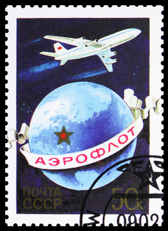 MOSCOW, RUSSIA - JANUARY 4, 2019: A stamp printed in USSR (Russia) shows Ilyushin (IL-86) Jetliner over globe, The Anniversary of Aeroflot serie, circa 1983のeditorial素材