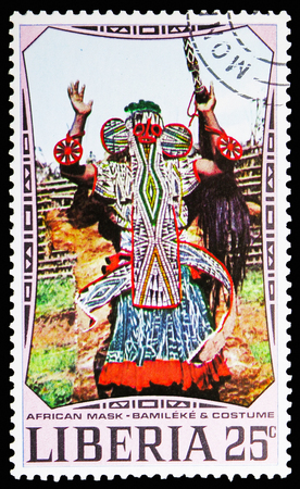 MOSCOW, RUSSIA - NOVEMBER 10, 2018: A stamp printed in Liberia shows Bamileke mask and costume, African Masks serie, circa 1971のeditorial素材