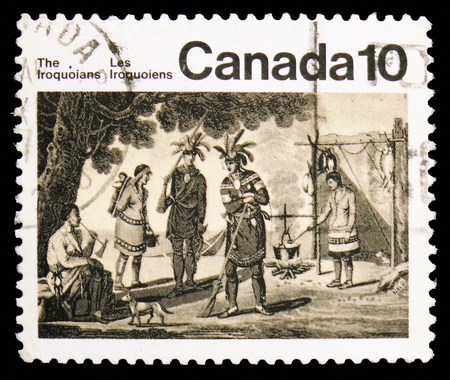 MOSCOW, RUSSIA - NOVEMBER 10, 2018: A stamp printed in Canada shows Iriquoian Encampment, Native Amerindians of Canada serie, circa 1976のeditorial素材