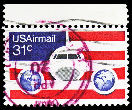 MOSCOW, RUSSIA - FEBRUARY 10, 2019: A stamp printed in United States shows Plane, Globes and Flags,...