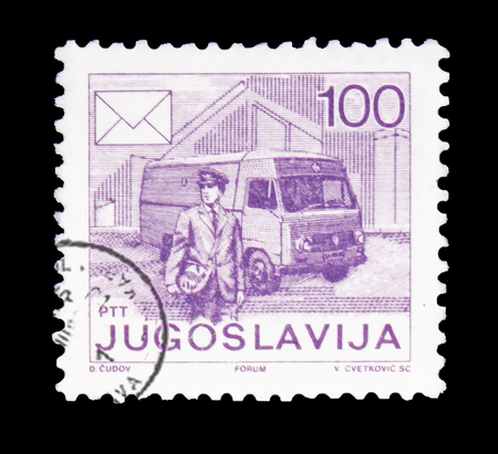 MOSCOW, RUSSIA - FEBRUARY 10, 2019: A stamp printed in Yugoslavia shows Postman and postal car, Postal service serie, circa 1986のeditorial素材