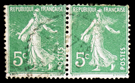 MOSCOW, RUSSIA - FEBRUARY 10, 2019: Two postage stamps printed in France shows Seeding machine, Semeuse lined background serie, circa 1907のeditorial素材