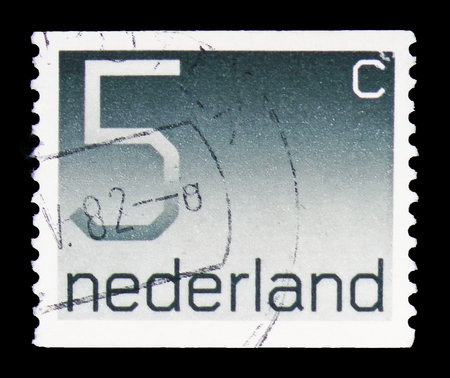 MOSCOW, RUSSIA - FEBRUARY 10, 2019: A stamp printed in Netherlands shows Numeral, 5 Dutch cents, Figure type "Crouwel" serie, circa 1976のeditorial素材