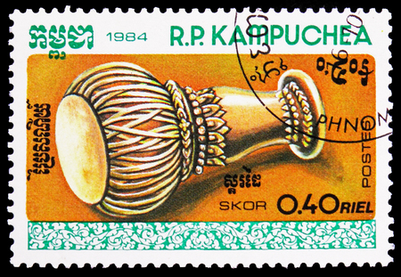 MOSCOW, RUSSIA - FEBRUARY 21, 2019: A stamp printed in Kampuchea (Cambodia) shows Skor, Traditional instruments serie, circa 1984のeditorial素材