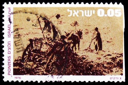 MOSCOW, RUSSIA - FEBRUARY 21, 2019: A stamp printed in Israel shows Pioneers clearing the land, serie, circa 1976のeditorial素材