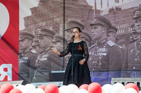 MOSCOW, RUSSIA - MAY 9, 2019: Khasanova Alina sing a song on a scene during event dedicated to Victory Day on May 9, 2019のeditorial素材