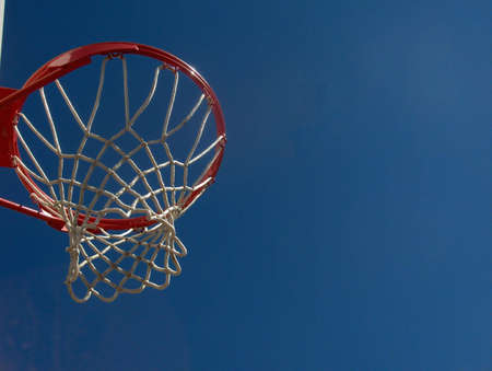 Isolated view of a basketball hoop against a blue skyの写真素材