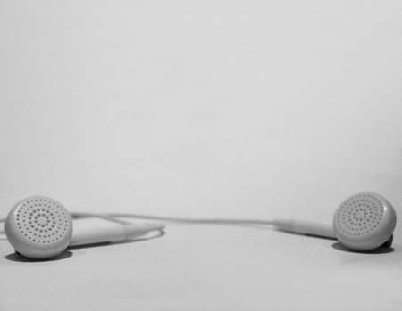 Earphones lying on white suitable for a backgroundの写真素材