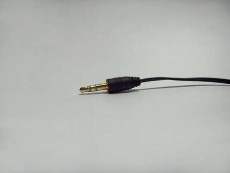 Black electronic plugin on gradient white backgroundの写真素材