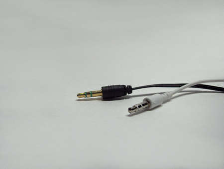 Black and white electronic plugins on gradient white backgroundの写真素材